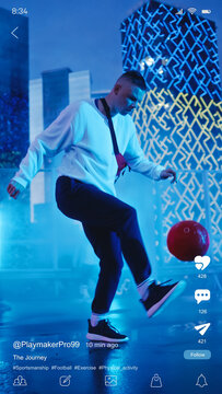 Vertical Mobile Interface: Social Media Mockup App With Stylish Male Street Football Player Practicing With A Ball On The Neon Lit Rooftop Of Skyscraper. Ideal Template for Social Media Posts, Stories