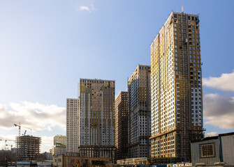 The construction company is building a multi-storey residential complex at a high level of readiness. Several multi-storey buildings are at the stage of installing the facade and glazing the windows.
