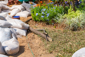 stacks of white sandbags full of garden gravel stone for paving in the recreation park