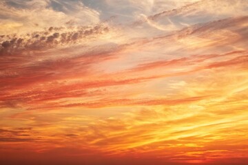 Fototapeta premium textured watercolor background in shades of yellow orange and red reminiscent of a sunset sky, yellow orange red abstract watercolor background, orange hues