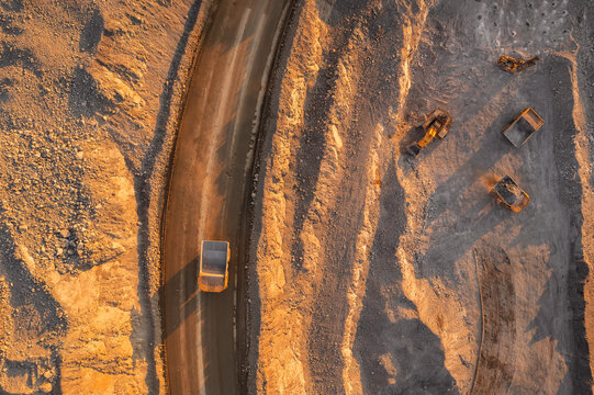 Panoramic of open pit mine industry, aerial view. Big yellow mining truck for coal working in quarry
