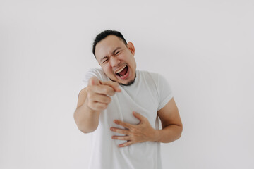 Big laugh funny face Asian man in white t-shirt isolate on white.