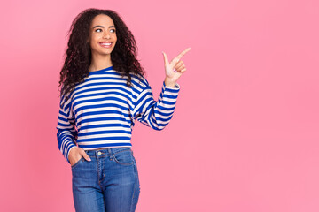 Photo of pretty young girl direct finger empty space wear striped pullover isolated on pink color background