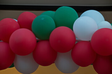 Colorful white, green and red balloons hung like a garland festively decorate buildings at Christmas and New Year, Sofia, Bulgaria   
