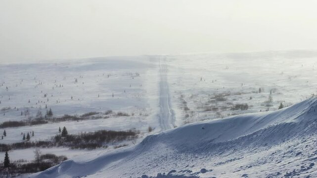 Difficult winter roads in the wide open spaces of Arctic forest-tundra. There is no way here in summer. Russia, Komi Republic oil and gas region, former Soviet Gulag. Siberia
