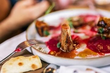 Tasty sliced roast meat  with cranberry sauce on a plate. Food and drink concept.