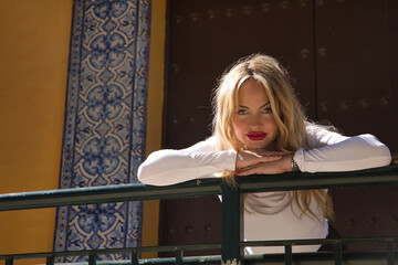 Portrait of a young, beautiful, blonde woman, wearing a white T-shirt, with a sweet and tender...