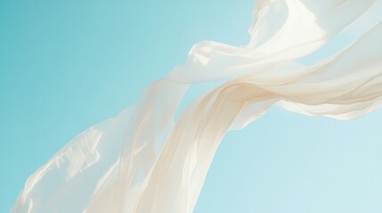 Flowing white fabric gracefully sways in the wind set against a vivid azure sky, creating a serene and ethereal atmosphere.