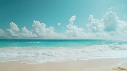 Obraz premium Idyllic tropical beach with soft white sand, gentle turquoise waves, and fluffy clouds against a clear blue sky, providing ample copy space for text.