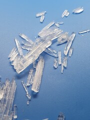Menthol-crystals with light blue background reflecting in light, looking like frozen ice crystals