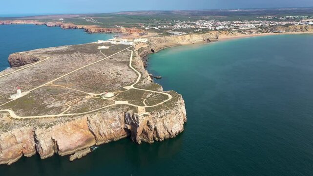 Aerial view of Sagres, Vila do Bispo, in the southern Algarve of Portugal. Mareta Beach. Famous travel destination for surfers and water sport. Sagres Fortress and lighthouse Drone going forward.