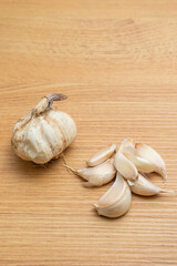 Close-up of a garlic head on a kitchen counter, showcasing its texture, ideal for culinary or cooking-related projects.