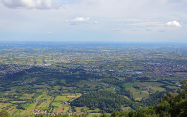 view of the vast plain with cultivated fields and city houses in the distance seen from above