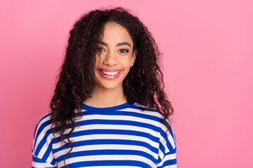 Portrait of nice young girl toothy smile empty space wear striped pullover isolated on pink color background