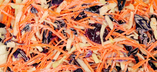 Fresh crunchy coleslaw salad background with cabbage, carrot and onion with mayonnaise