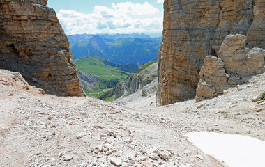 steep scree slope descending from the mountain to the valley bottom in the European Alps in Italy