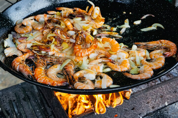 Traditional Paella Cooking on Open Fire Outdoors &ndash; Spanish Cuisine in Action