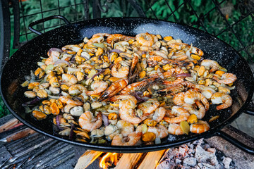 Traditional Paella Cooking on Open Fire Outdoors – Spanish Cuisine in Action