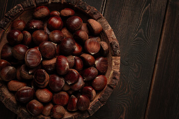 fresh chestnuts, in a wooden bowl, top view, no people,