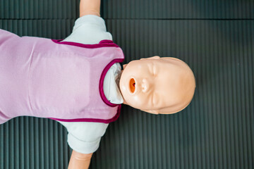 Infant CPR Training Dummy on Exercise Mat Ready for Lifesaving Practice in First Aid Classes