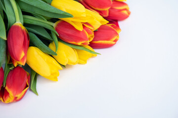 Bouquet of flowers. Yellow and red Tulips on white background. Beautiful flowers for valentines and wedding scene. Valentines and 8 March Mother Women's Day concept.