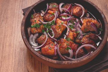 fried meat, pork kebab, ketsi in a clay pan, with red onions and herbs, homemade, no people,