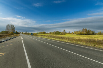 A road with a clear blue sky above it