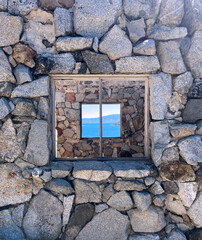 Stone wall with window overlooking Lake Tahoe.