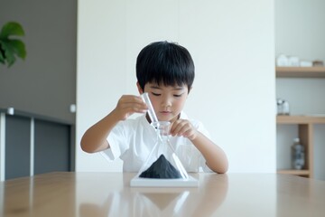 Naklejka premium Minimalist Photography of Asian Boy Observing Hourglass for Time Concept Posters