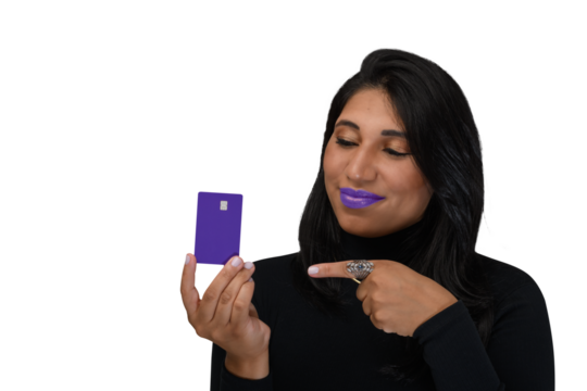 woman holding credit card, points to credit card and smiles confidently