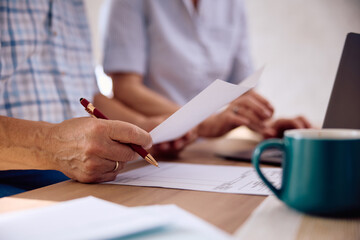 Close up of senior man planning household budget with his wife at home.