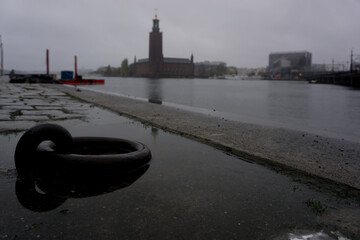 Buildings by river during rainy day