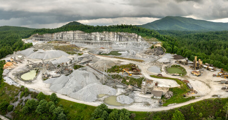 Aerial view of open pit mining site of limestone materials extraction for construction industry