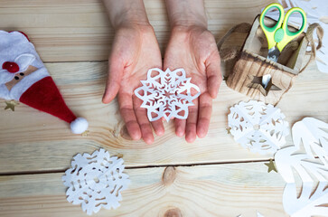 A snowflake made from paper with your own hands gracefully decorates a winter interior, adding warmth and a cozy atmosphere