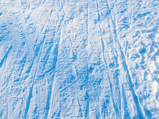 A snow-covered river with an ice-covered area with footprints creates an atmosphere of winter adventure and freshness