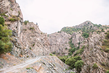 Rugged mountain landscape with steep cliffs and lush greenery
