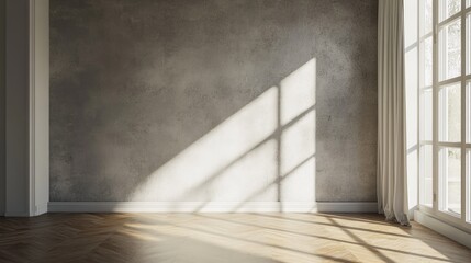 Sunlit empty room with textured wall, hardwood floor, and large window.