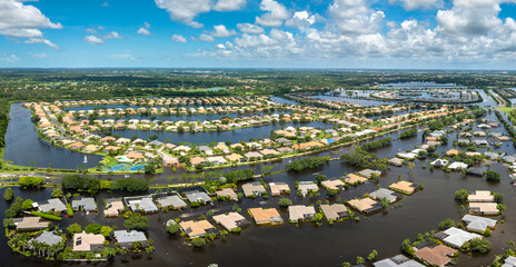 Flooded residential area with underwater houses from hurricane rainfall water in Florida suburban...