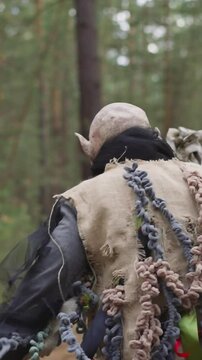 animator in monster costume runs away in forest, children's camp