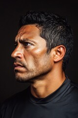 Fototapeta premium A person looking away from the camera, wearing a black shirt