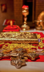 Christian Greek orthodox church, golden religious church tools. cross, bible, candles, and other various items used in orthodox ceremonial mass, byzantine rite