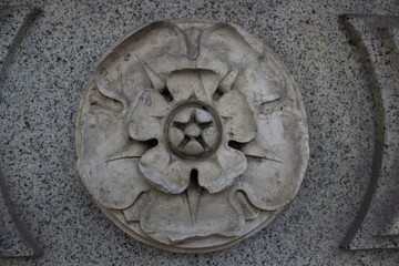 part of the decor, in the form of a flower, made of concrete. Antique building.