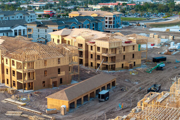 Wooden frames of new Florida apartment condos under construction. Development of residential housing in the USA © bilanol