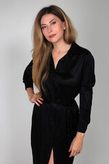 Portrait of a beautiful fashion girl blond in the studio in a nice blue dress