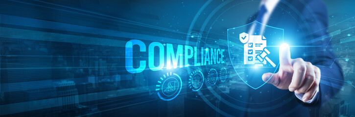 Businessman hand touches a shield, compliance and safeguarding go hand in hand. Concept represents...