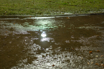 Night lantern lights in park in snowfall at night