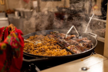 Polish traditional food at Christmas fair in Poland. Selling traditional hot food at the market. Food festival with food stall kiosk, open-air outdoor fair market