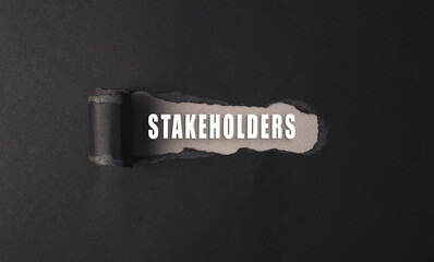 Black and white image of a torn piece of paper with the word stakeholders