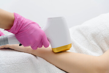 laser epilation, hair removal procedure, young beautiful caucasian smiling brunette woman lying on...