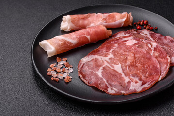 Antipasto jamon, prosciutto, sausage, sliced with tomatoes, salt and spices